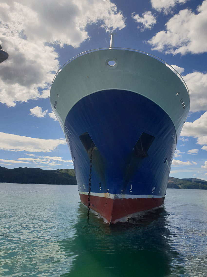 Very close to the front of a ship