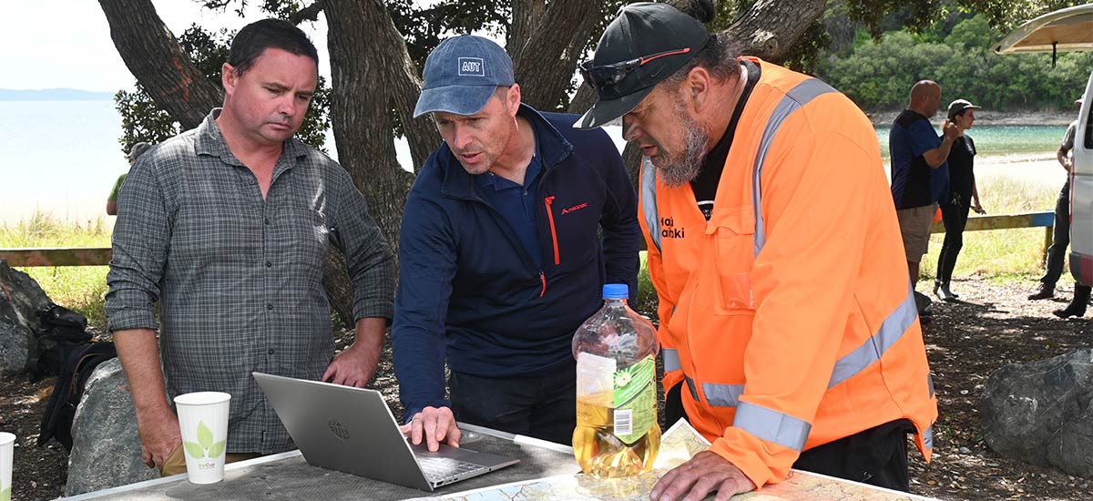 Three people checking possible sites to visit